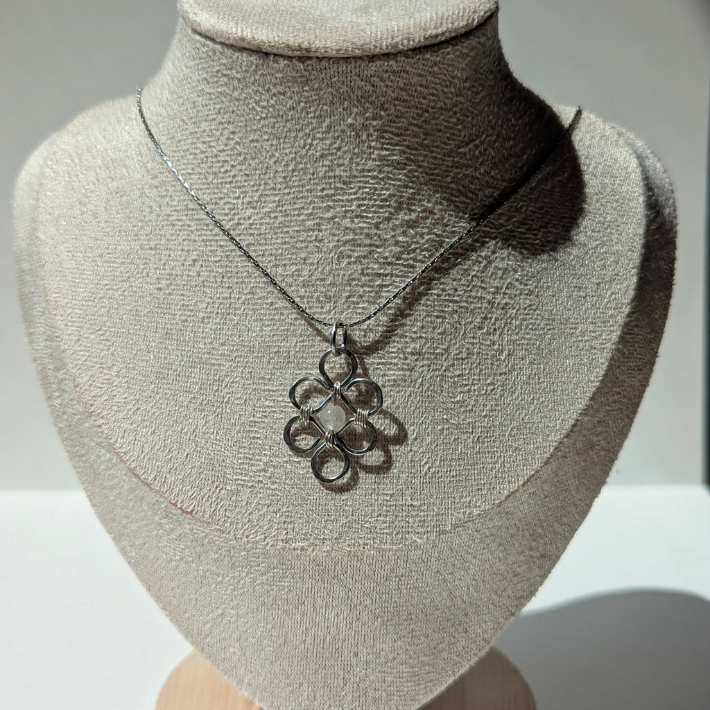 Necklace on a mannequin bust with a neutral background